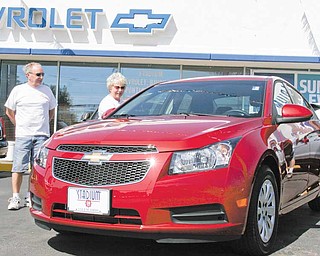 James and Ruth Cain of Salem check out a 2011 Chevrolet Cruze at Stadium GM Superstore in Salem on Wednesday. James Cain, a GM retiree, said he was impressed with the car.
