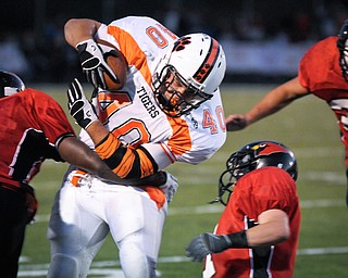 Howland's (40) number not on roster) tacks on yards against the Canfield defence after a short reception during their game on Friday. Photo/Mark Stahl