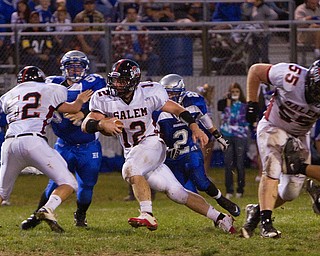 Geoffrey Hauschild|The VIndicator.Salem's Trent Toothman (12) is able to push through the Hubbard line, taking advantage of blocks from teamates Steve Manypenny (52) and Mike King (55) while running downfield during the second quarter of a match up between Salem and Hubbard at Hubbard Stadium on Friday evening.