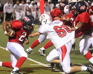 FITCH - (51) Jeff Protain tries to hold off (68) Mike Aylward as (2) Demitrious Davis looks for yards during their game Friday night in Austintown. - Special to The Vindicator/Nick Mays