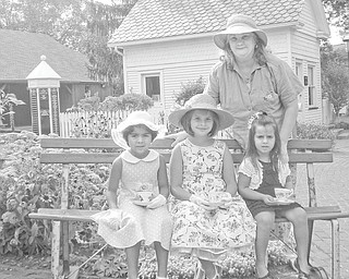 These “pretend pioneers” enjoy tea time in the garden at Western Reserve Village, a historical site where the Holborn Herb Growers Guild hosts its annual tea party. The girls, from left to right, are Sheryln Michele Himes, Annabelle Morgan Himes and Katie Koulianos, and in back is Lois Martin-Uscionowski.