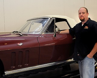 The Vindicator: Sara C. Tobias
Manager Rich Seaman poses with one of his personal favorite cars, a 1966 Corvette. The Corvette, along with many of the cars in the museum was restored by employee Bob Darney, who previously worked for GM for 30 years before joining TP Tools.