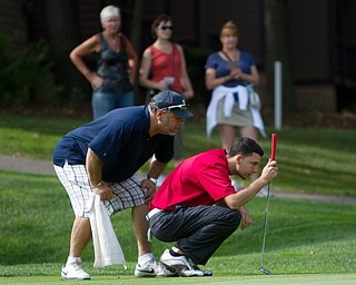 Geoffrey Hauschild|The Vindicator
Vincenzo Romeo eyes up a put on hole 16 at The Lake Club during the open division of the Greatest Golfer in the Valley tourney.