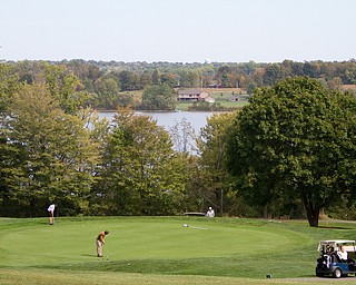 Geoffrey Hauschild|The Vindicator
Golfers go to work on the green of Hole 17 The Lake Club during the open division of the Greatest Golfer in the Valley tourney.