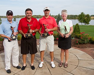 Geoffrey Hauschild|The Vindicator
Flight 2 winner, James Lapolla, of Trumbull CC, Flight 3 winner, Tom Onesti, of The Lake Club, Open division winner Mike Porter, of Tippecanoe, and Ladies winner, Joan Ash, of Mill Creek, hold their trophies at the Lake Club on Saturday afternoon following the conclusion of the open Greatest Golfer in the Valley tourney.