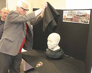 Dr. Humphrey D. Germaniuk and Bazetta Detective Joe Sofchek unveil a sculpture done by the FBI of a bust of a man whose body was found near Mosquito Lake in 2006. Call Bazetta police at 330-638-5503 if you have any information on the man.