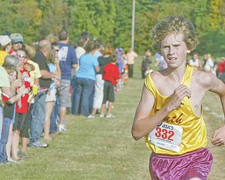 South Range High junior Ryan Roush runs across the fi nish line of the Suburban League 5K cross country meet at the Canfi eld Fairgrounds on Tuesday.