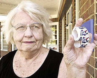 Susan McAfee of Poland Township shows a roll of stamps she found outside the Poland post office. She returned them Tuesday.