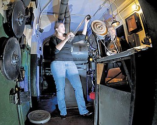 Sarah Durham, general manager of Salem Community Theatre, checks out an old piece of film that was left inside the theaterÕs projection room. The theater closed as a movie house in the 1980s and has since served as a venue for plays.