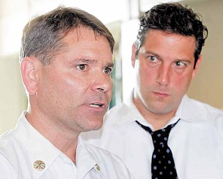 Warren Fire Chief Ken Nussle, left, makes remarks about the grant with Ryan at his side. Because of the city's economic woes, 11 firefighters were laid off in early 2009.