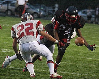 FOOTBALL - (24) Braylen Wigfall is stripped by (15 hidden) Carl Brown as (22) Matt Szorady tries to recover the ball Friday night in Campbell. - Special to The Vindicator/Nick Mays