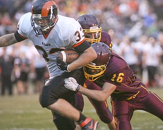 ROBERT K. YOSAY | THE VINDICATOR..Mineral Ridge #33 joe Porter breaks the last tackles of #15 David Buzzaco ( behind him and .#16 David Peterson (yes both davids ) as Mineral Ridge scores from 22 yards out during first half action Mineral Ridge vs South Range at The Raider Field -..-30