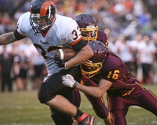 ROBERT K. YOSAY | THE VINDICATOR..Mineral Ridge #33 joe Porter breaks the last tackles of #15 David Buzzaco ( behind him and .#16 David Peterson (yes both davids ) as Mineral Ridge scores from 22 yards out during first half action Mineral Ridge vs South Range at The Raider Field -..-30