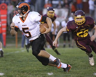 ROBERT K. YOSAY | THE VINDICATOR..#5 for the rams Evan Evans makes the turn for a first down as SR #52 Robbie Graphovac gives chase as Mineral Ridge vs South Range at The Raider Field -..-30