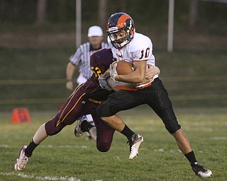 ROBERT K. YOSAY | THE VINDICATOR..#10 Mineral Ridges Mike Keleman puts in the extra effort as SR #52 Robbie Grahovac tries to tackle him behind the line for a one yard loss in first quarter action - Mineral Ridge vs South Range at The Raider Field -..-30