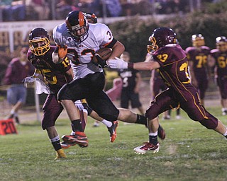 ROBERT K. YOSAY | THE VINDICATOR..Mineral Ridges #33 Ryan Porter Takes off on a 22 yard TD run as SR #15 David Buzzacco and #53 Jake Mitchell try to correl him - Mineral Ridge vs South Range at The Raider Field -..-30