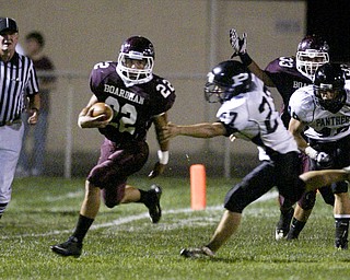 William D. Lewis The Vindicator Allen Starkey of Boardman cuts downfield duriong Friday action at Boardman Team mate Carmen Tarantino looks on past Perry defenders during 1 rst qtr action.