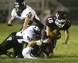 William D. Lewis The Vindicator Nick bounavolonta of Boardman is brought down by a host Perry defenders during 1 rst qtr action Friday.