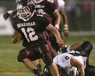 William D. Lewis The Vindicator Tyler Wallsof Boardman eludes Perry defenders during 1 rst qtr action Friday.