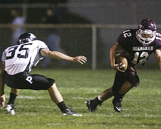 William D. Lewis The Vindicator Tyler Walls of Boardman eludes Perry defenders during 1 rst qtr action Friday.