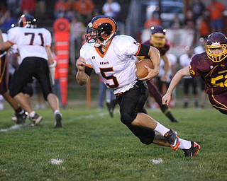 ROBERT K. YOSAY | THE VINDICATOR..#5 for the rams Evan Evans makes the turn for a first down as SR #52 Robbie Graphovac gives chase as Mineral Ridge vs South Range at The Raider Field -..-30