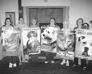 Above are Megan Martini; Stephanie Lambert; Lora Herbert; Heather Jurina, manager of the Columbiana County Humane Society shelter; Sally Geary; and Lisa Shoff, all holding posters of adoptable pets, made to look as though they are movie stars for an upcoming “red carpet” fundraiser.