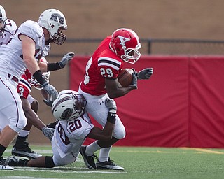 Geoffrey Hauschild|The Vindicator.Southern Illinois' Terrell Wilson (20) brings down Youngstown State University's Dominique Barnes (29) during the first quarter of a game at Youngstown State University's Stambaugh Stadium on Saturday afternoon.