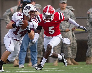 Geoffrey Hauschild|The Vindicator.Southern Illinois' Joe Allaria (14) makes his way down field while being pursued by YSU's Randy Louis (5) during the first quarter of a game at Youngstown State University's Stambaugh Stadium on Saturday afternoon.
