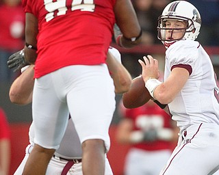 Geoffrey Hauschild|The Vindicator.Despite an advance by YSU's Torrance Nicholson, Southern Illinois' Chris Dieker (5) is able to throw a pass during the second half of a game at Youngstown State University's Stambaugh Stadium on Saturday afternoon.