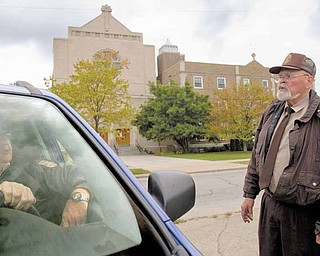 Bob Jacobs, of Youngstown, and Wally Heck, of New Springfield, talk Sunday morning while working security outside St. Dominic Church, 77 E. Lucis Ave. Thomas J. Repchic, 75, and Jacqueline Repchic, 74, two St. Dominic parishioners, were shot Saturday afternoon near the intersection of Southern Boulevard and Philadelphia Avenue. Thomas Repchic died of his injures, and his wife is in the hospital. They’re the second and third St. Dom’s members to fall victim to a shooting this year.