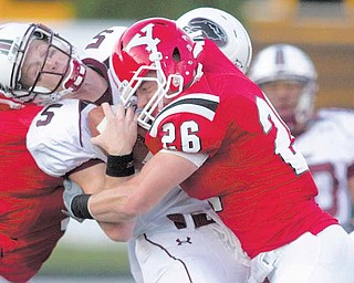 Geoffrey Hauschild|The Vindicator .YSU's David Rach (26) brings down Southern Illinois quarter back Chris Dieker (5) during the third quarter on Saturday afternoon.