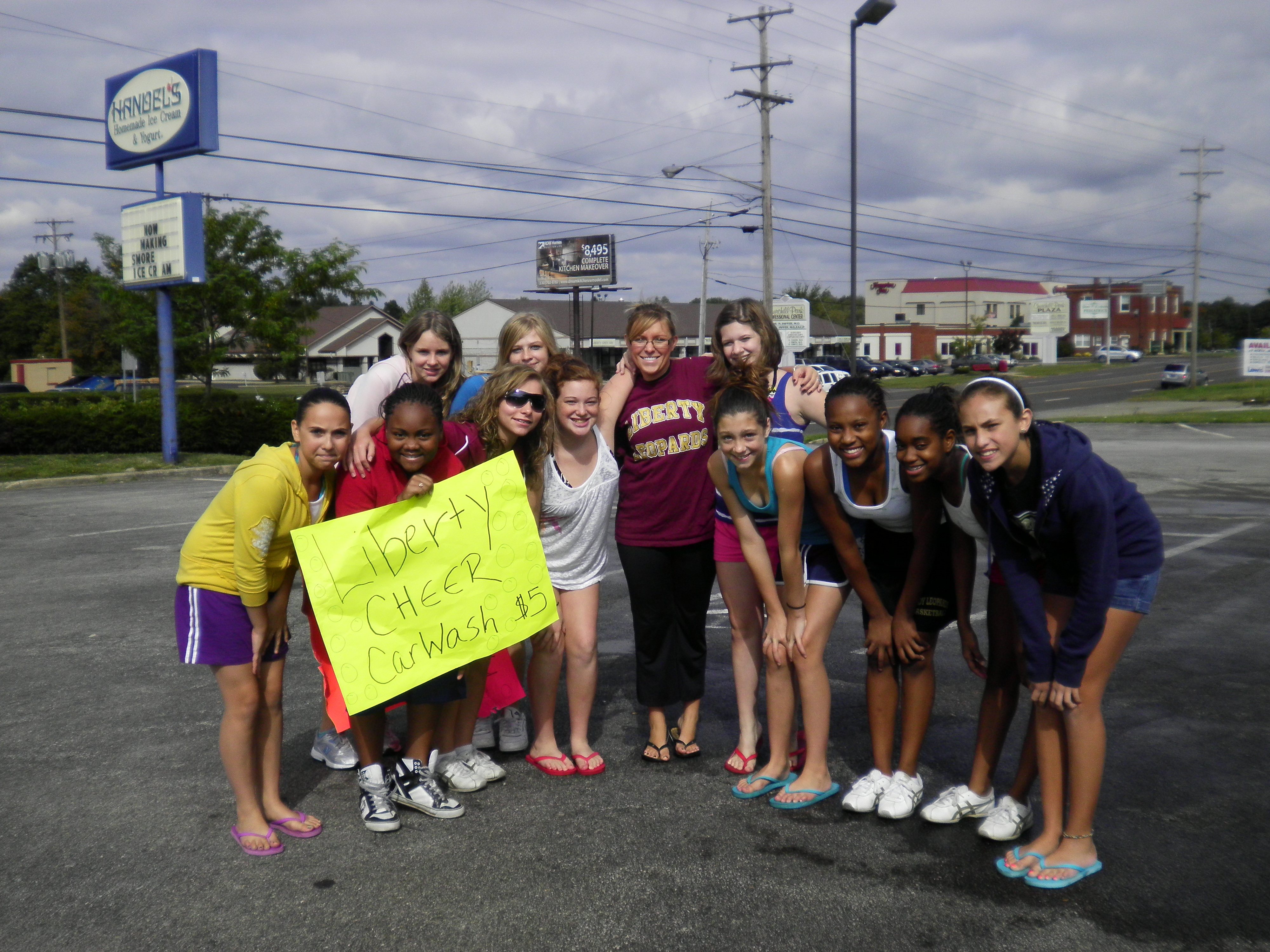 7th and 8th grade Liberty cheerleaders spend a Saturday afternoon throwing a carwash to raise money.
