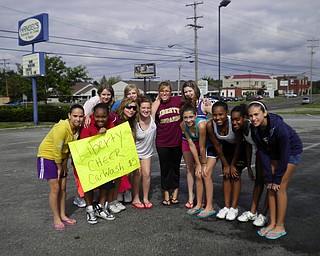 7th and 8th grade Liberty cheerleaders spend a Saturday afternoon throwing a carwash to raise money.