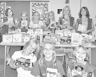 Under the guidance of their troop leader, Vicki Palmer, members of Girl Scout Troop 420 of Canfield, discussed what to do with the money they earned selling Girl Scout cookies. The girls, all third-graders, came up with the idea to buy books for kids in the hospital. The troop contacted a local wholesaler about purchasing $100 worth of books. The wholesaler responded with a box full of donated books. The books will be donated to Akron Children’s Hospital of Mahoning Valley at 4:45 p.m. Monday. The girls are, front, from left to right, Peyton Munera, Holly Eberly and Abby Palmer. In the back are Julie Porterfield, Ella Mitchell, Grace Ramun, Libby Finsen, Anna Dudash, and Emily Porterfield. Missing from the picture is another of the 10 troop members, Zoe Guzman.