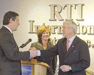U.S. Rep. Tim Ryan, D-17th, left, exchanges a cordial greeting Tuesday with RTI International Metals chief executive Dawne Hickton and Airbus Americas chairman Allan McArtor during a press conference at RTI’s titanium manufacturing facility in Niles. The visit to the Niles plant emphasized the 30-year relationship between the airplane manufacturer and RTI, which supplies components for all Airbus aircraft.