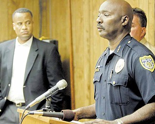 Police Chief Jimmy Hughes and Youngstown Mayor Jay Williams, left, announce the arrest of one man and the search for another.