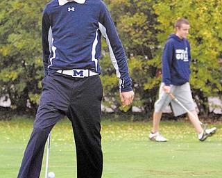 Geoffrey Hauschild|The Vindicator.Troy Dombroski juggles a golf ball while practicing his putting with the rest of the McDonald Golf Team at Mahoning Country Club on Tuesday evening.