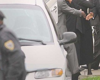 Family members console one another as they exit St. Andrewes African Methodist Episcopal Church in Youngstown, where funeral services were Tuesday for Vivian Martin, a real-estate agent who was killed last week.