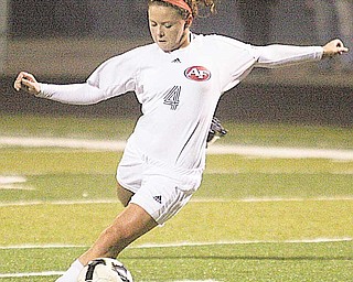 Fitch senior midfi elder Kristen Schmidt (4) fi res a shot down into position during Wednesday’s game against the
Uniontown Lake Blue Streaks at Fitch’s Falcon Stadium in Austintown. Schmidt’s two assists helped to pave the
way for the Falcons’ 3-0 win, a victory that helped them regain some critical ground in the Federal League.