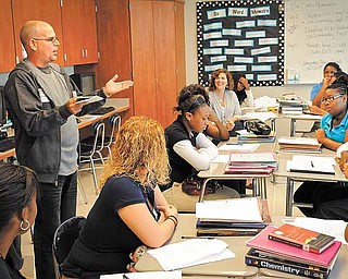 Cuban poet Raul Hernandez Ortega works with student in Jennifer Walker's AP Lit/Comp class at Youngstown's East High School on Wednesday.