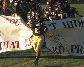 Robert Smith-Harris leads the Liberty Leopards onto the field.