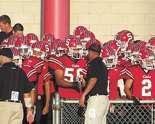 Struthers Wildcats coach Ron Iarussi wishes his son, senior Keary Iarussi, No. 56, good luck before a recent game.