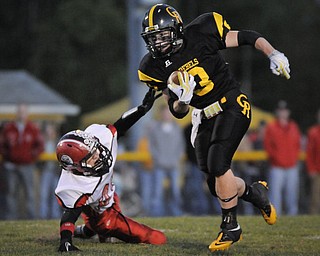 Crestview's Adam Coppock breaks the tackle of Columbiana's Britton Steiginga during their game at Crestview on Friday night. Photo/Mark Stahl