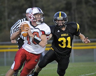 Columbiana QB Austin Barbato (10) eludes the tackel of Crestview's Tom Oliver (31) during their game at Crestview on Friday night. Photo/Mark Stahl