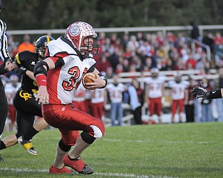 Crestview's Nick Roncone (30) looksfor a hole against the Crestview defence during their game at Crestview on Friday night. Photo/Mark Stahl