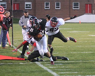 FOOTBALL - (21) Austin Noel fights for yards as (83) Richard Bledsoe and (9) Dennis Williams help with the stop Friday night in Salem. - Special to The Vindicator/Nick Mays