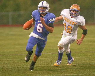 ROBERT K. YOSAY | THE VINDICATOR.. QB #6 blue Devils Jeffrey Clegg takes off for the sidelines to set up another Blue devil first down - chasing him is #12 Josh Melhorn - Western Reserve Blue Devils vs Southern Local Indians at Western Reserve Stadium ..-30-..