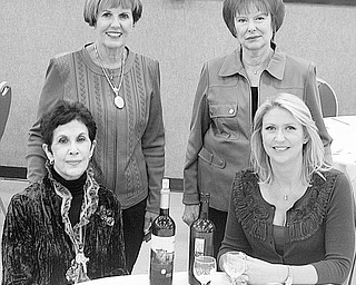 Nick Mays | Special to The Vindicator: Standing, from left, Julie Costas, Geri Kosar, and seated, Jeanne Saadey and Cindy Matthews are ready for the Rich Center fundraiser titled Napa Valley to the Mahoning Valley. The annual event will take place Oct. 23 at Our Lady of Mount Carmel Church hall.