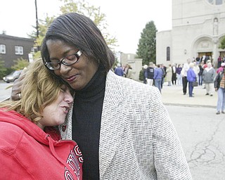 William d Lewis The Vindicator Lisa Mansell, left, a member of St Dom's Church embraces Janet Tarpley, Y-town 6th ward councilperson at a rally aturday outside St Dom's church.