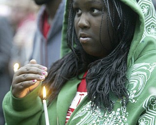William d Lewis The Vindicator Marsacia Shine holds a candle at a rally Saturday outside St Dom's church.